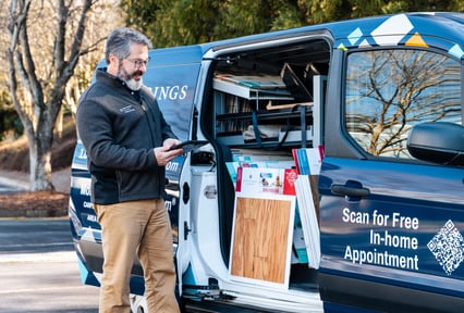 Home service professional reviews samples from a branded van offering free in-home appointments.