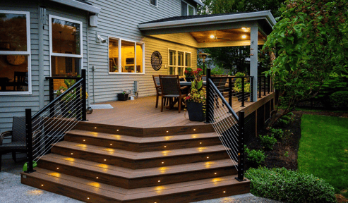 Image of a back patio with lights on the stairs