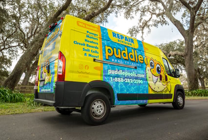 Puddle Pool Services repair division van with colorful branding and service information on the side.