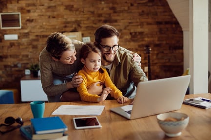 A family looking at a computer