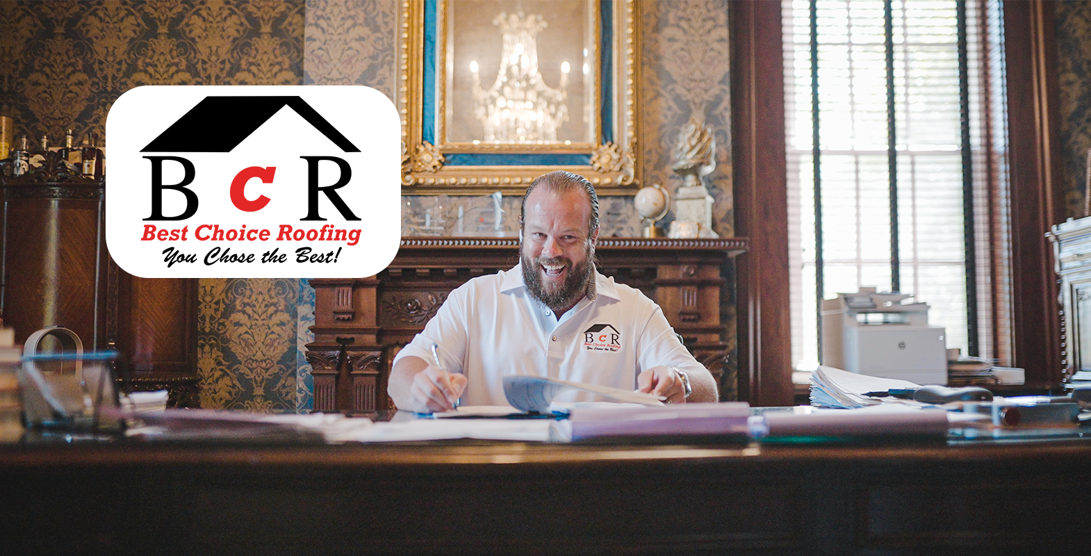 A man sitting at a desk writing