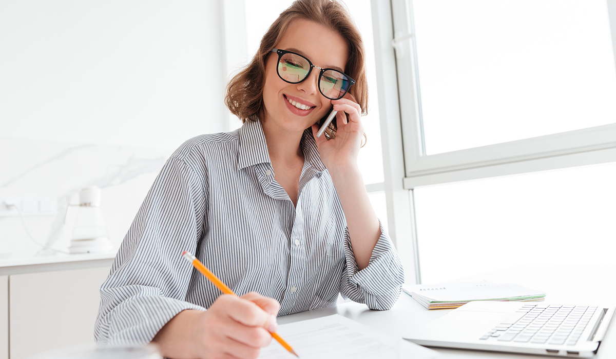A woman on the phone holding a pencil