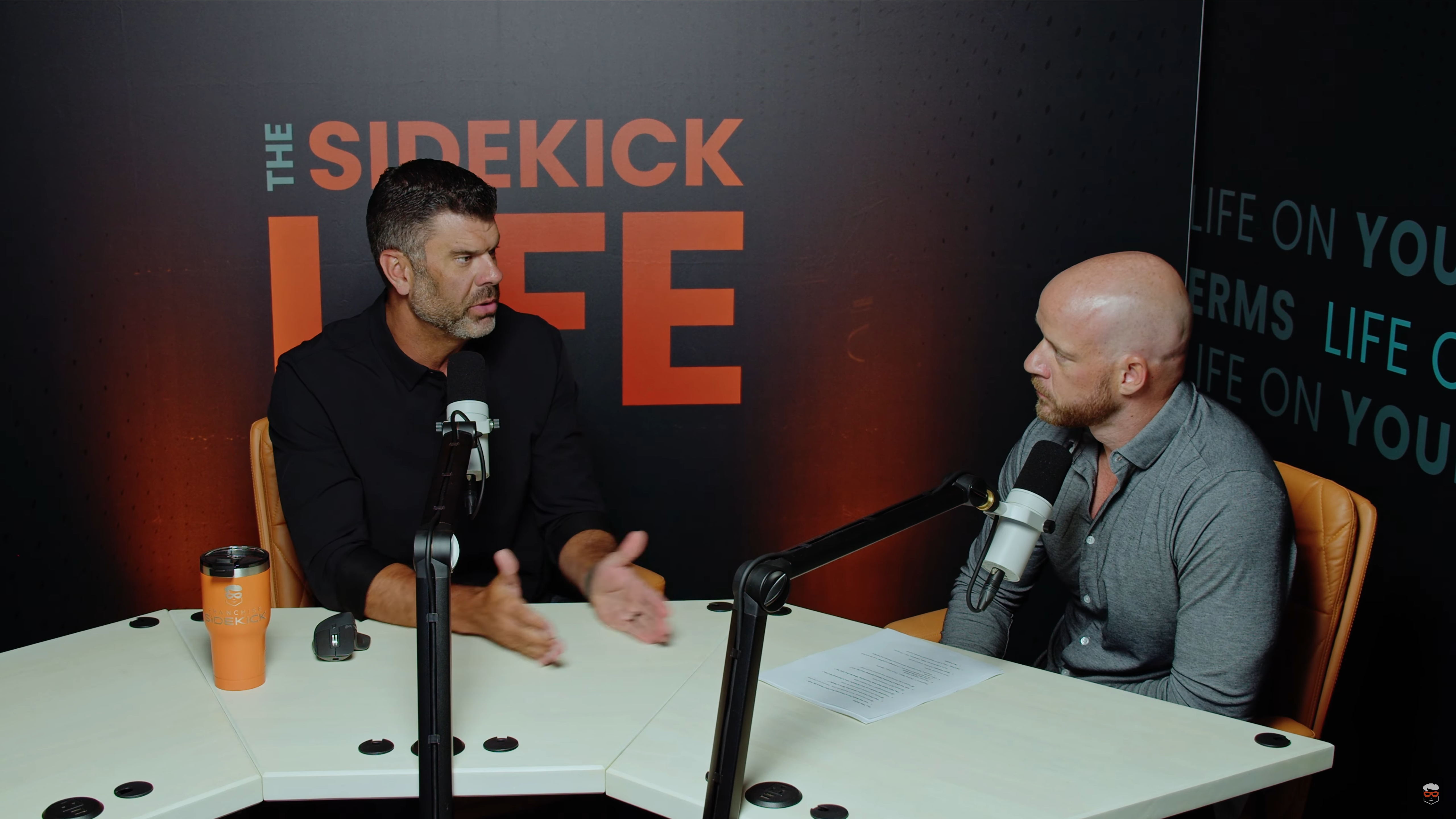 A photo of Ryan and Tyler looking at each other while speaking in 